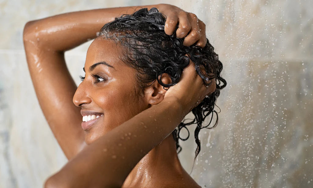 Woman washing her hair and scalp in the shower.