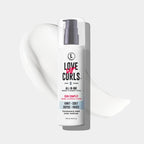 Bottle of Love Ur Curls hair care product on a white background