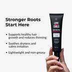 Hand holding a black serum tube labeled 'Love Ur Curls' with product benefits text on a white background