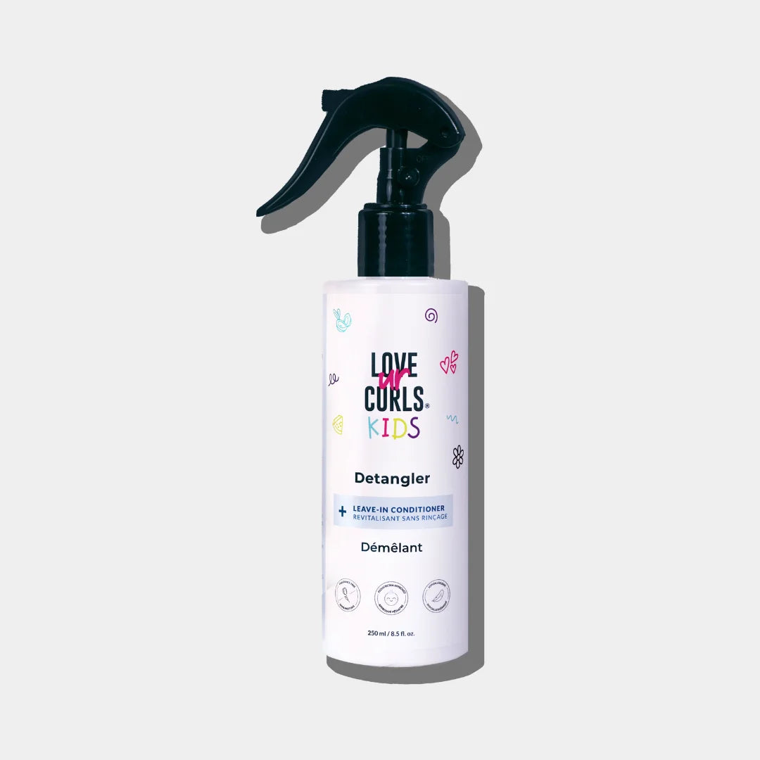 A bottle of 'Love Curls Kids' Kids Detangler with a spray pump. The label features multicolored design elements and text.