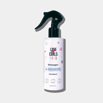 A bottle of 'Love Curls Kids' Kids Detangler with a spray pump. The label features multicolored design elements and text.
